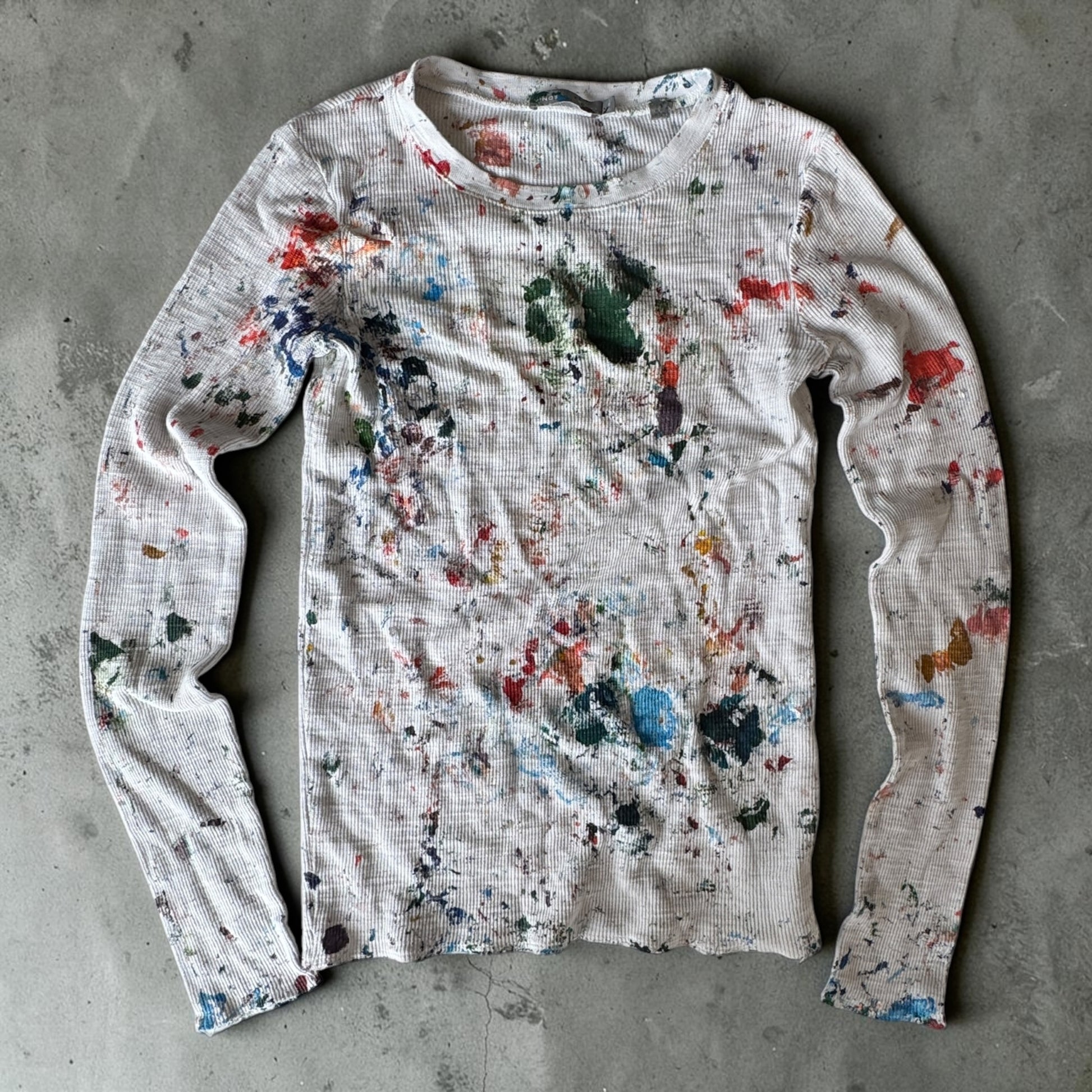 Custom paint-splattered white tee with blue paint
